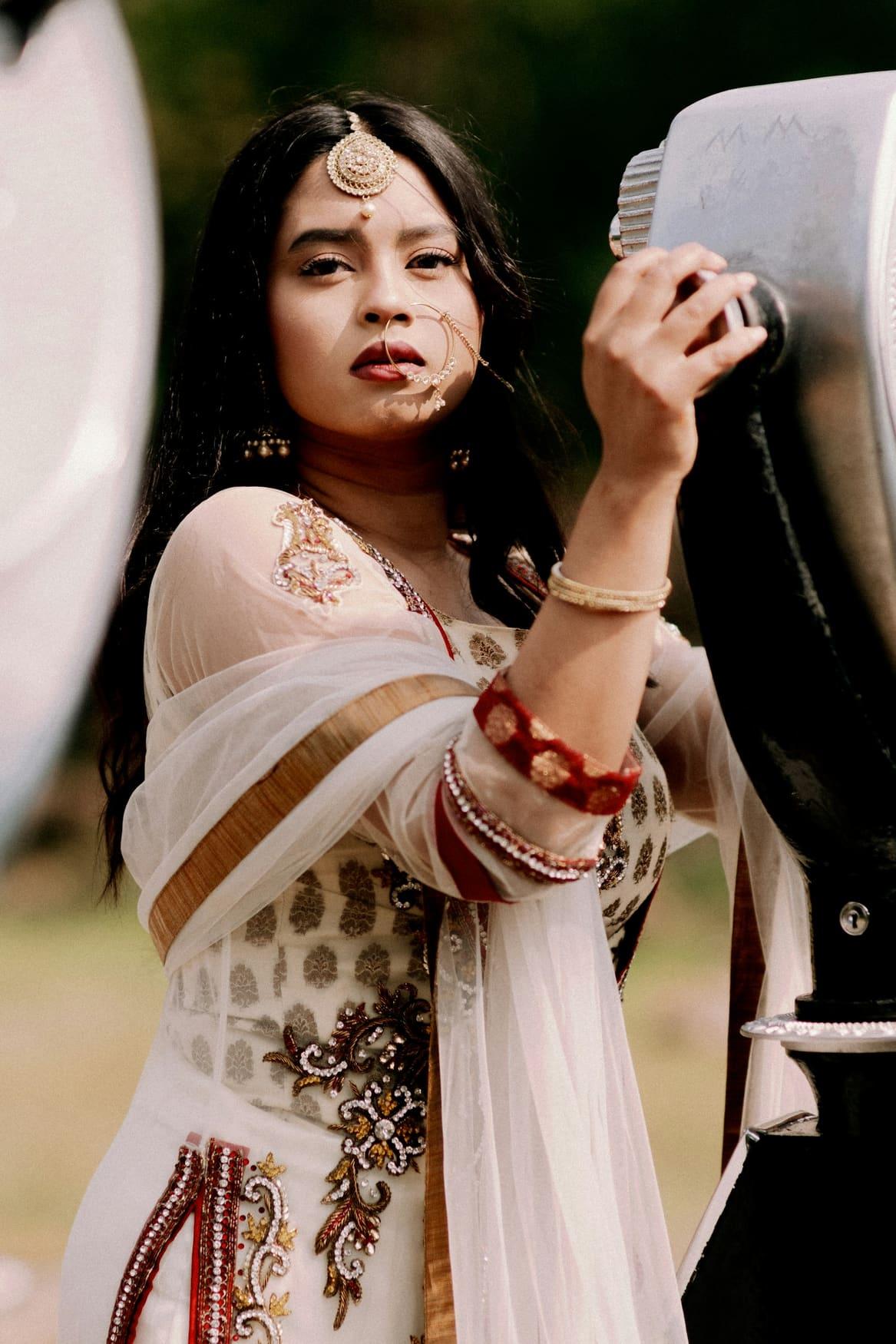 Woman in an ivory embroidered anarkali with gold work