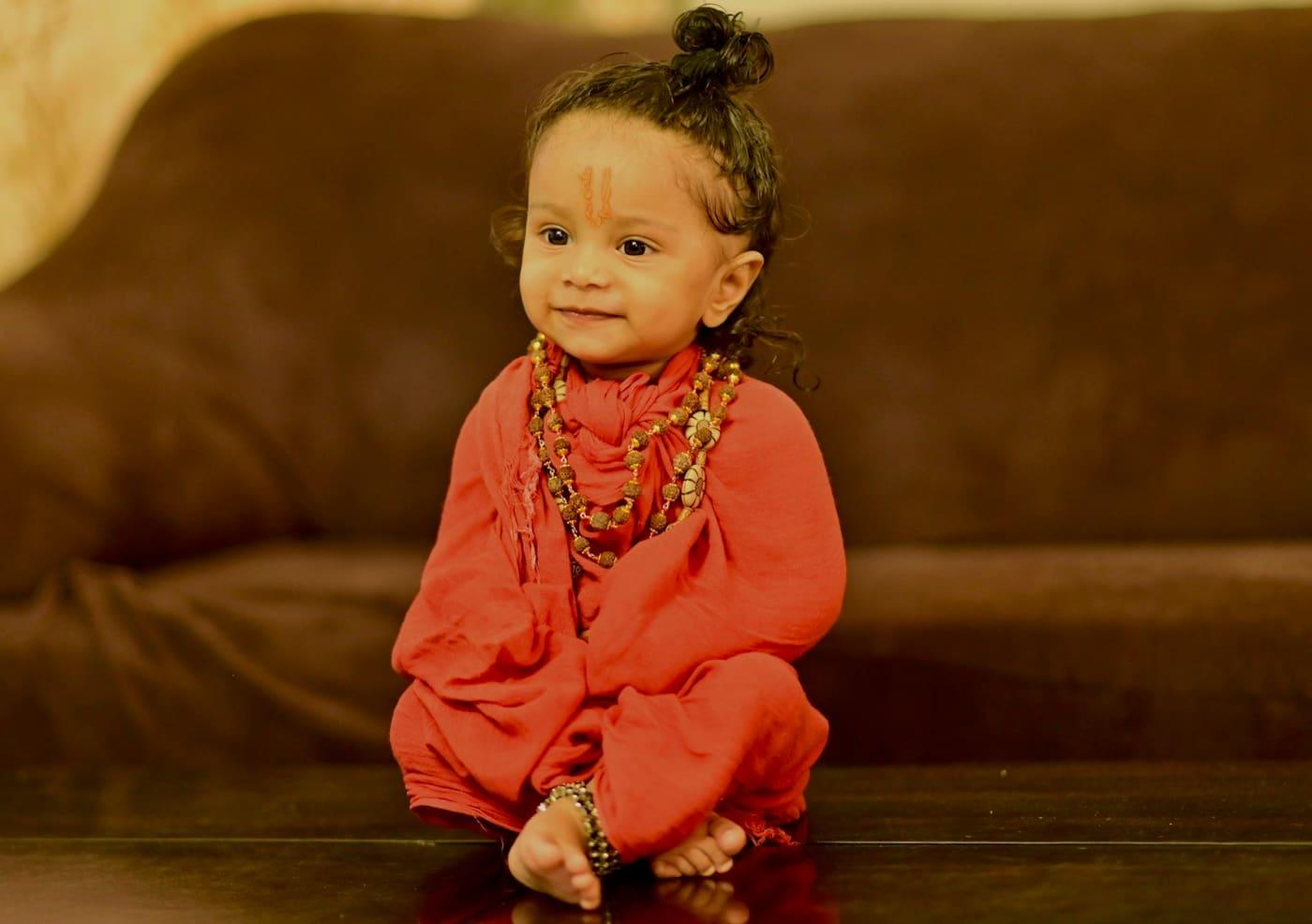 Smiling toddler in a saffron festive kurta