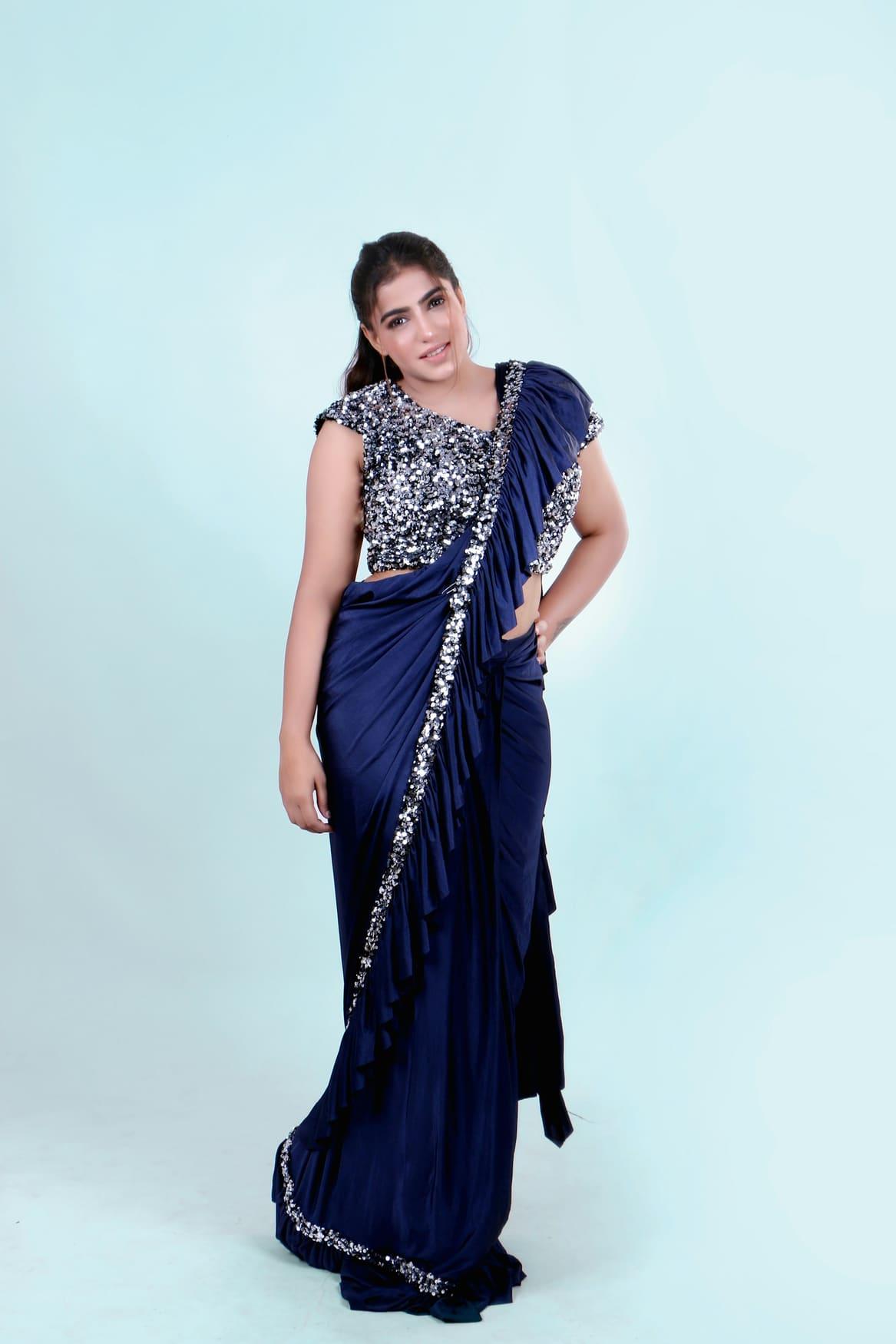 Woman in a midnight navy pre-draped saree with a sequinned blouse
