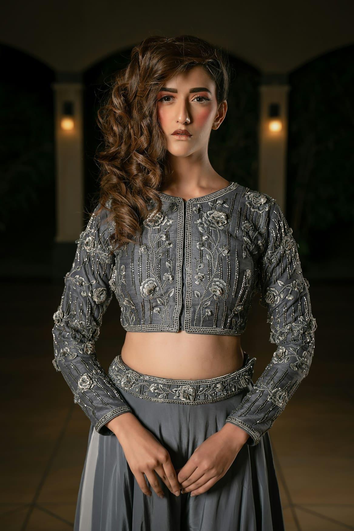 Woman in a silver-grey embroidered crop top and lehenga